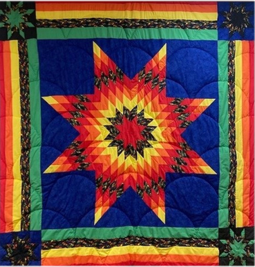 a colorful quilt with a star design on it, presented to the Montana Office of Public Instruction by Hays Lodge Pole Elementary School (2004). 