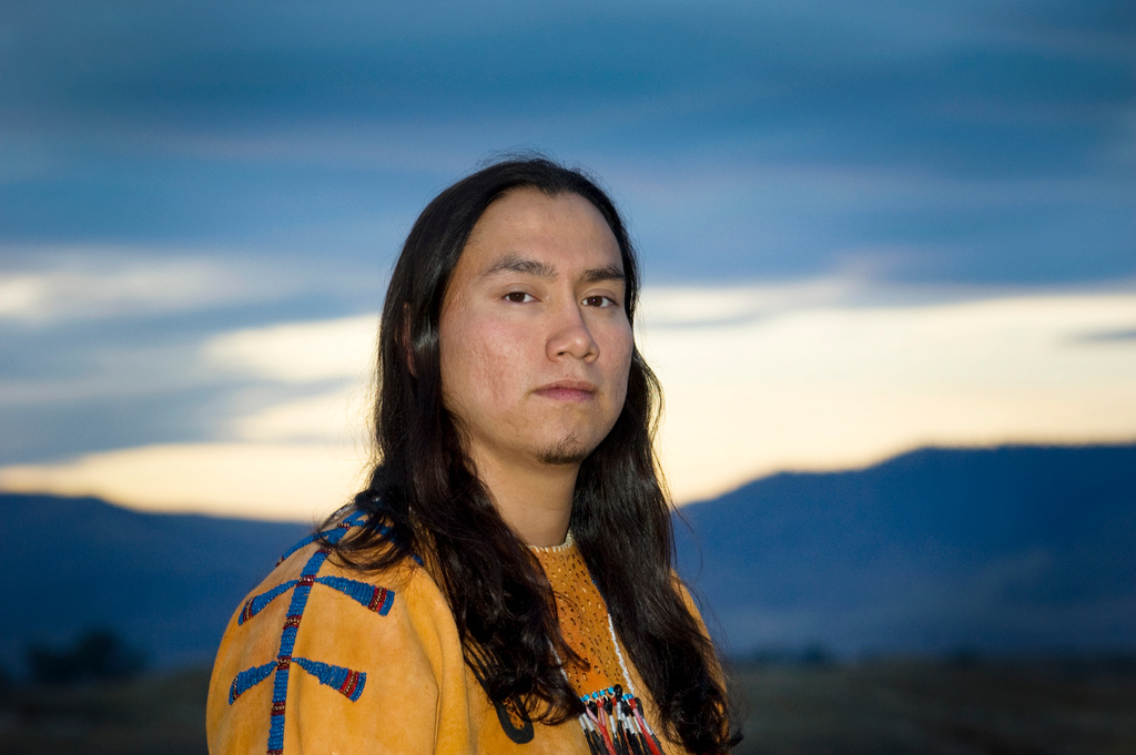 Serious Native American Man with Long Hair Wearing Beaded Bucksk